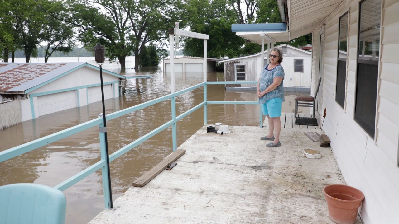Marlene Paul watches as the Arkansas River approaches her home in Webbers Falls, Oklahoma.