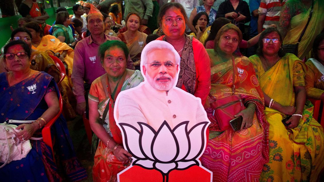 Bharatiya Janata Party (BJP) supporters celebrate with a cutout of Prime Minister Narendra Modi at their party office in Gauhati.