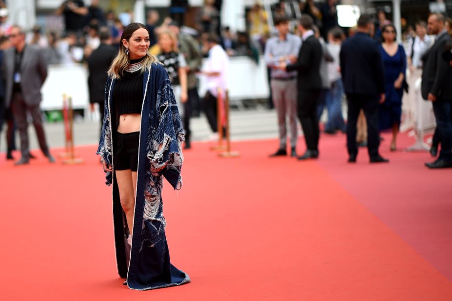 In a truly unexpected turn, Marion Cotillard wore a crop top and shorts, topped with a distressed denim kimono from Balmain. 