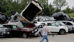 A worker walks past tornado-damaged Toyotas at a dealership in Jefferson City, Mo., Thursday, May 23, 2019 after a tornado tore though late Wednesday. (AP Photo/Charlie Riedel)