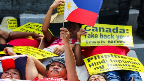 Environmental activists, belonging to the waste and pollution watch group EcoWaste coalition, protest outside the Canadian embassy in Manila, Philippines on May 21, 2019.