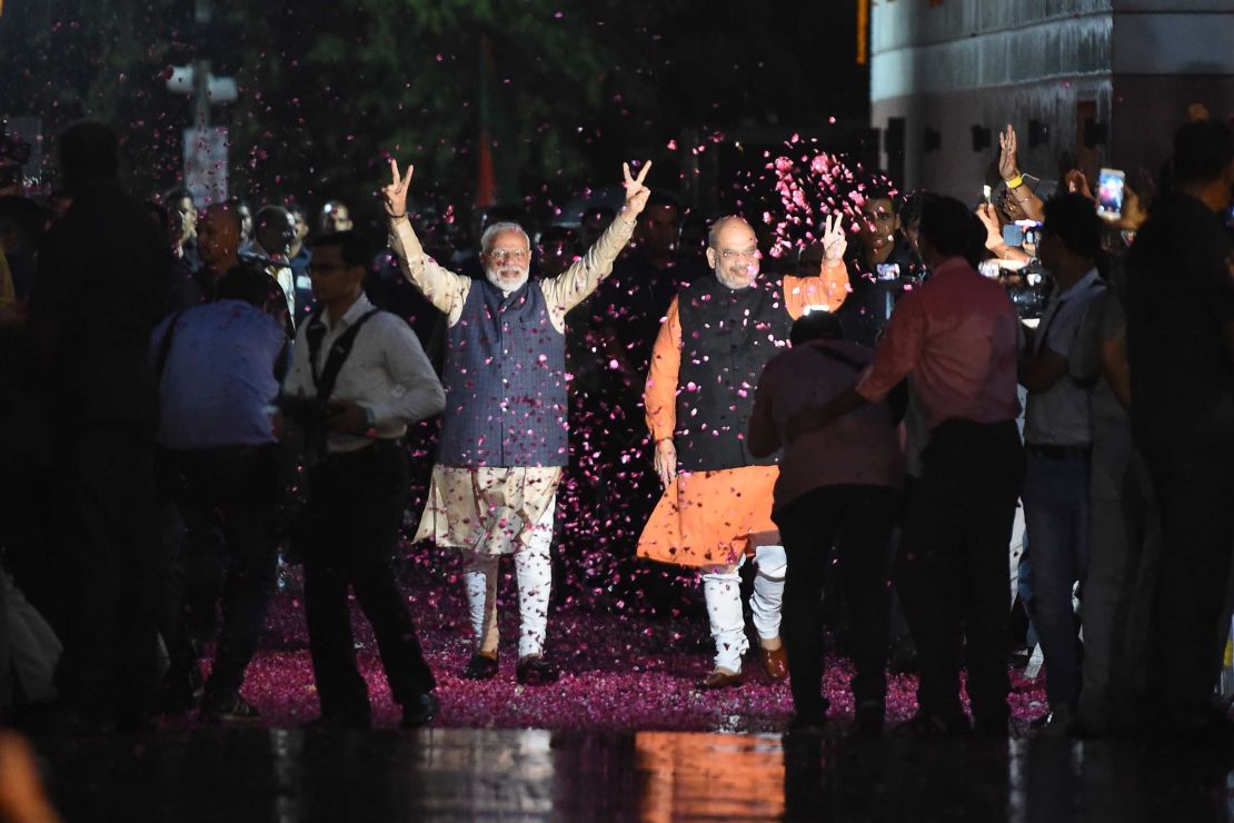 Indian Prime Minister Narendra Modi flashes the victory sign next to president of the ruling Bharatiya Janata Party (BJP) Amit Shah as they celebrate their victory in India's general elections.