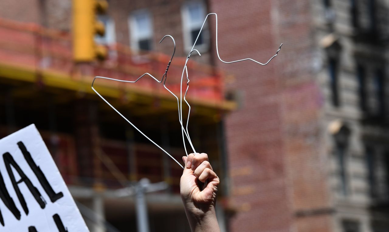 A woman holds coat hangers at an abortion rights rally in New York's East Village on Tuesday, May 21. Abortion rights supporters gathered across the United States <a href="https://www.cnn.com/2019/05/21/us/abortion-rights-protests/index.html" target="_blank">to show their opposition to a wave of laws attempting to restrict abortion.</a>