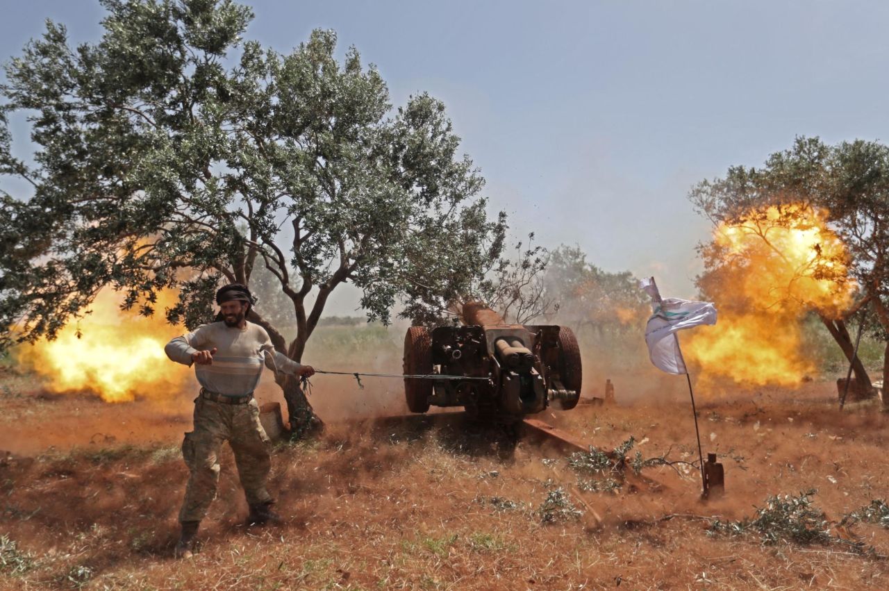 A Syrian rebel fires artillery at regime positions in the northern part of Syria's Hama province on Wednesday, May 22.