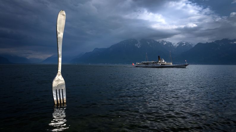<strong>Lake Geneva, Switzerland:</strong> A paddle steamer sails by a giant fork sculpture designed by Swiss artist Jean-Pierre Zaugg. 