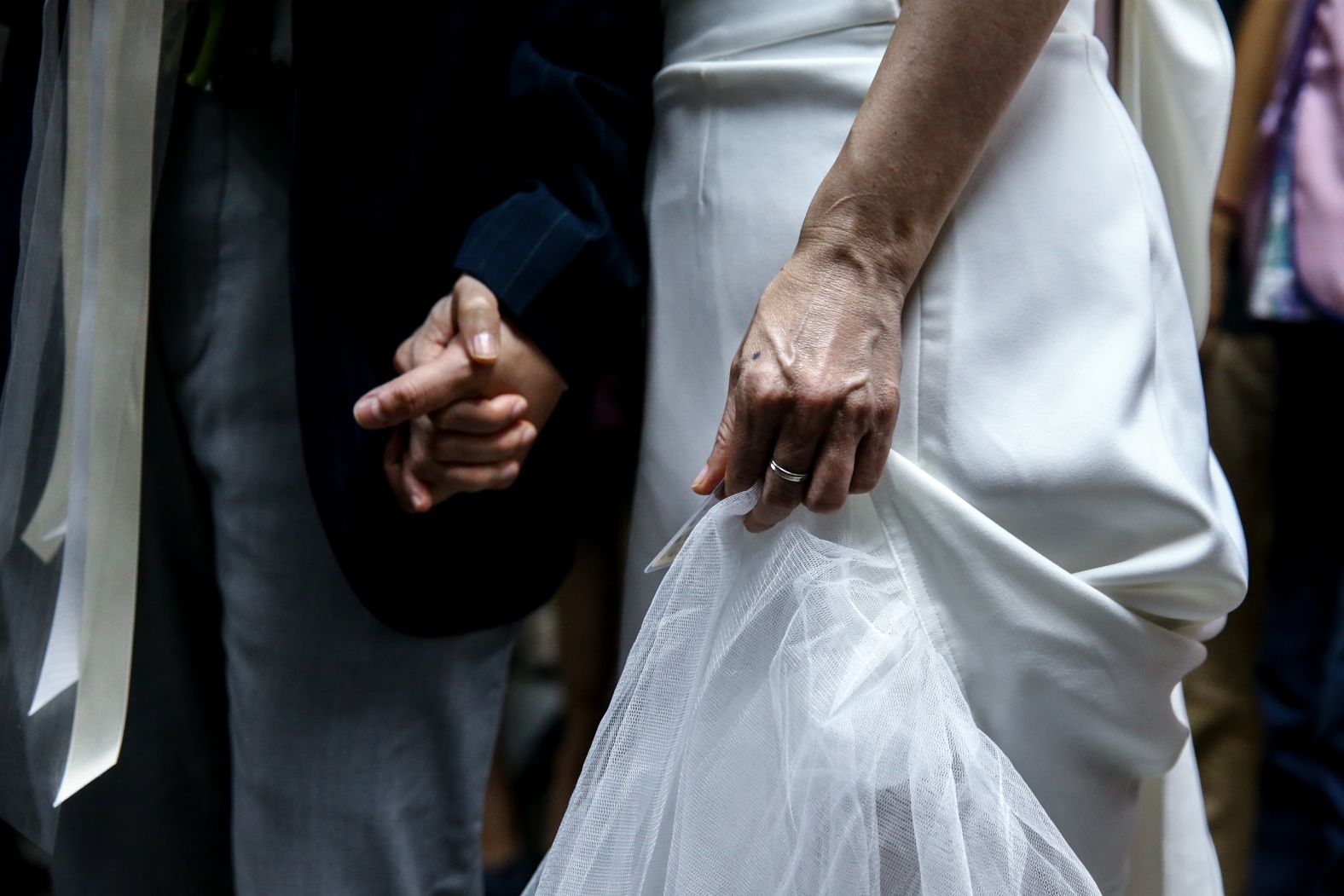 Couples hold hands in Taipei nearly a week after Taiwan's legislature passed a bill legalizing same-sex marriage.