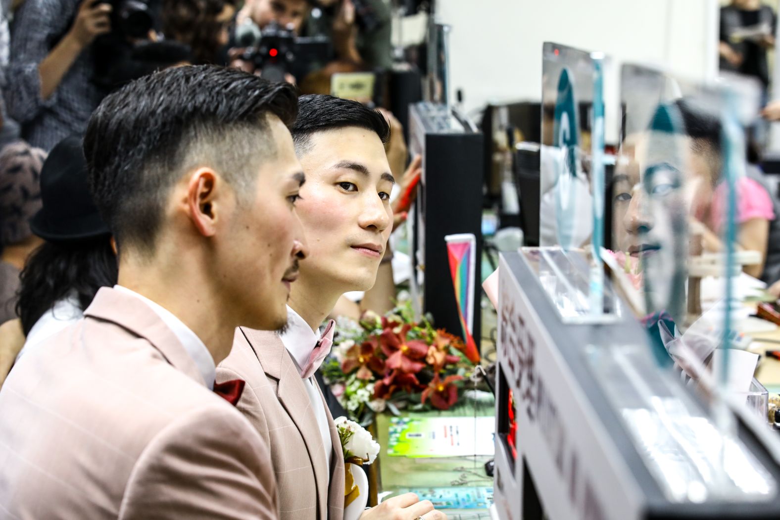 Marc Yuan, left, and Shane Lin, right, at the household registration office in Shinyi district in Taipei on Friday.