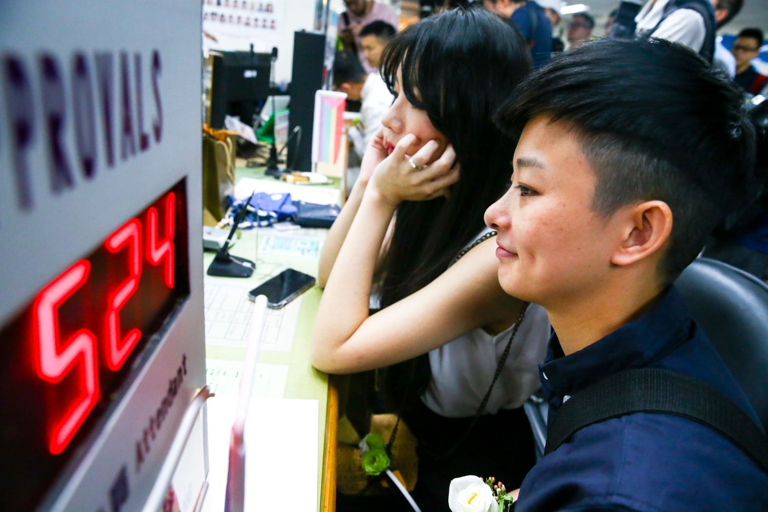 A lebsian couple awaits registering their marriage in Taipei.