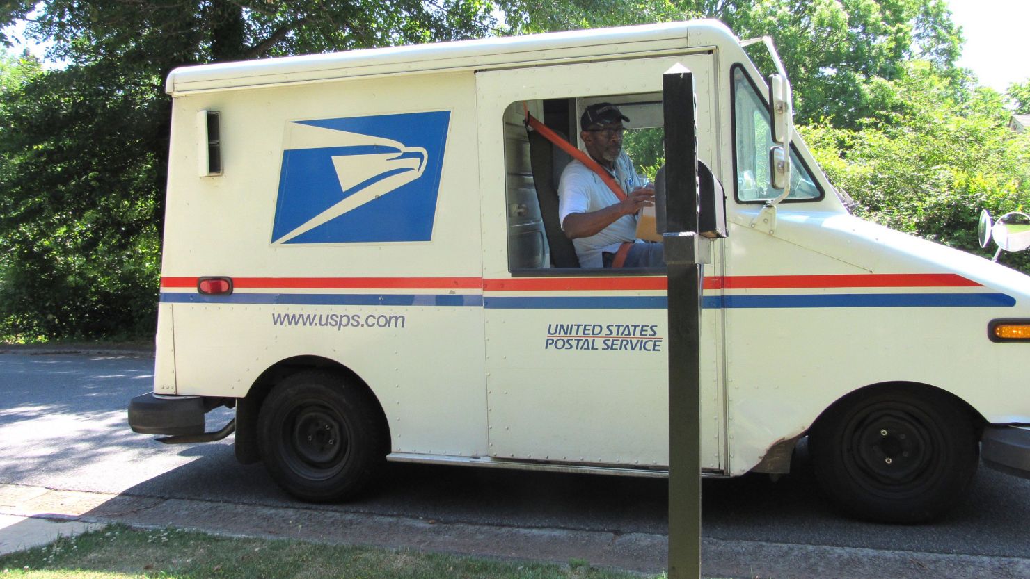 Floyd Martin delivers mail on his last day working for the US Postal Service before retirement.