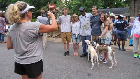 Martin takes pictures with neighbors. They've started a GoFundMe campaign for him to go to Hawaii.