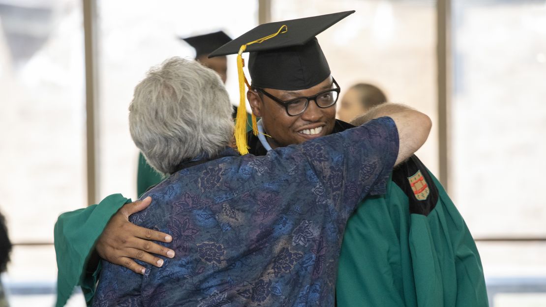 Torey Adams gets a hug at the ceremony.