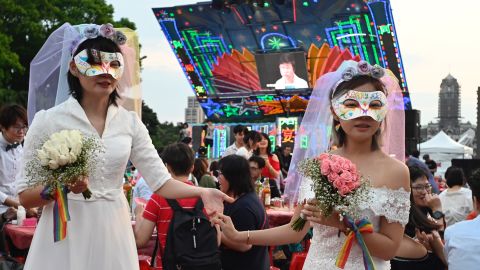 A gay couple poses for photographs during the wedding banquet, which took place in front of the Presidential Palace in Taipei.