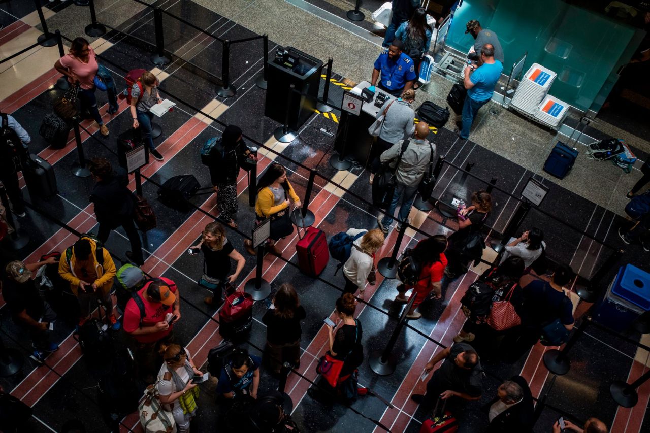Travelers wait in line to go through a security checkpoint at Ronald Reagan National Airport in Arlington, Virginia, on May 24. AAA calculated that <a href="https://www.cnn.com/travel/article/memorial-day-weekend-2019/index.html" target="_blank">almost 43 million Americans will be on the go</a> over the holiday weekend. That would be the second-highest number since the association started tracking holiday travel volumes in 2000.