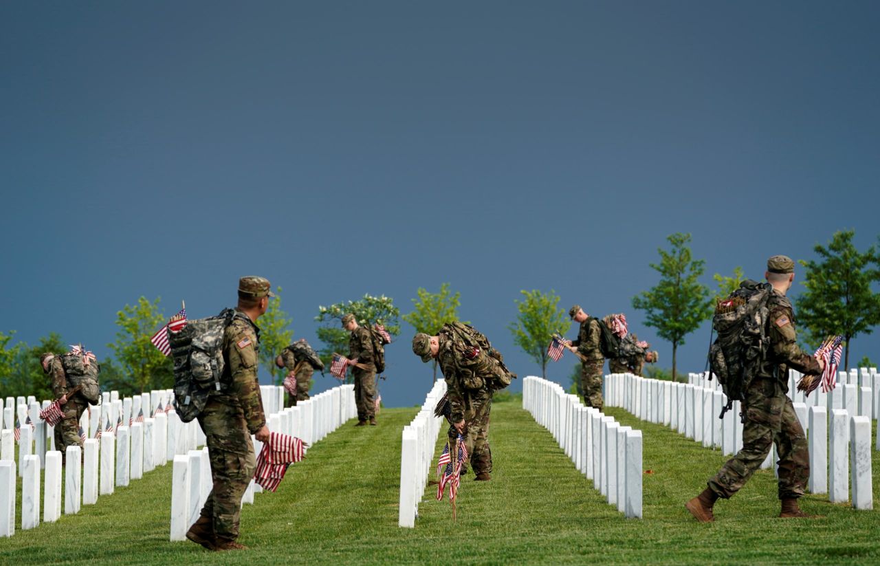 Soldiers take part in the Flags In event at Arlington National Cemetery.