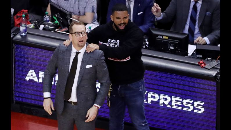 Drake massages Toronto Raptors head coach Nick Nurse's shoulder as the Toronto Raptors beat the Milwaukee Bucks 120-102 in Game 4 of the Eastern Conference NBA Final at Scotiabank Arena in Toronto, Canada on Tuesday, May 21. 