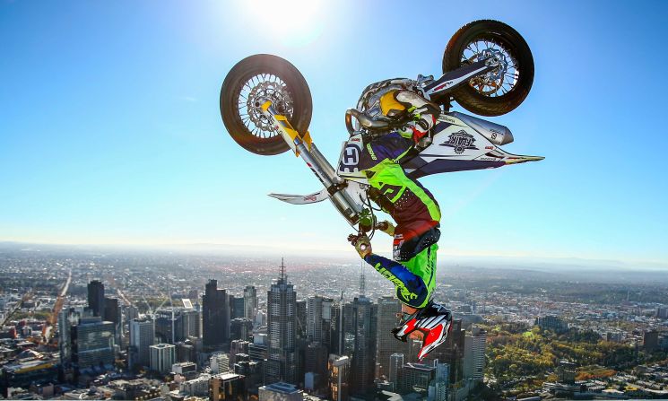 World Champion Trials bike rider Jack Field of Australia performs the highest backflip on a motorcycle ever recorded as he flips his motorbike upside down on the roof of Melbourne's Eureka Tower during an AUS-X Open media opportunity at Eureka Tower on Wednesday, May 22 in Melbourne, Australia. 