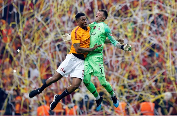 Galatasaray's Fernando Muslera and Ryan Donk celebrate winning the Super Lig over Istanbul Basaksehir F.K. at Turk Telekom Arena in Istanbul, Turkey, on Sunday, May 19. 