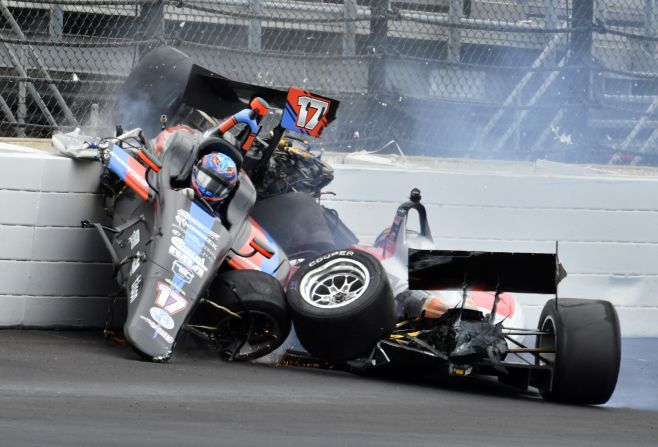 The car driven by Chris Windom (17) rides on the top of the car driven by David Malukas after a crash in the fourth turn during the running of the Indy Lights Freedom 100 IndyCar auto race at Indianapolis Motor Speedway, Friday, May 24 in Indianapolis. Both drivers walked away from their cars after the crash.