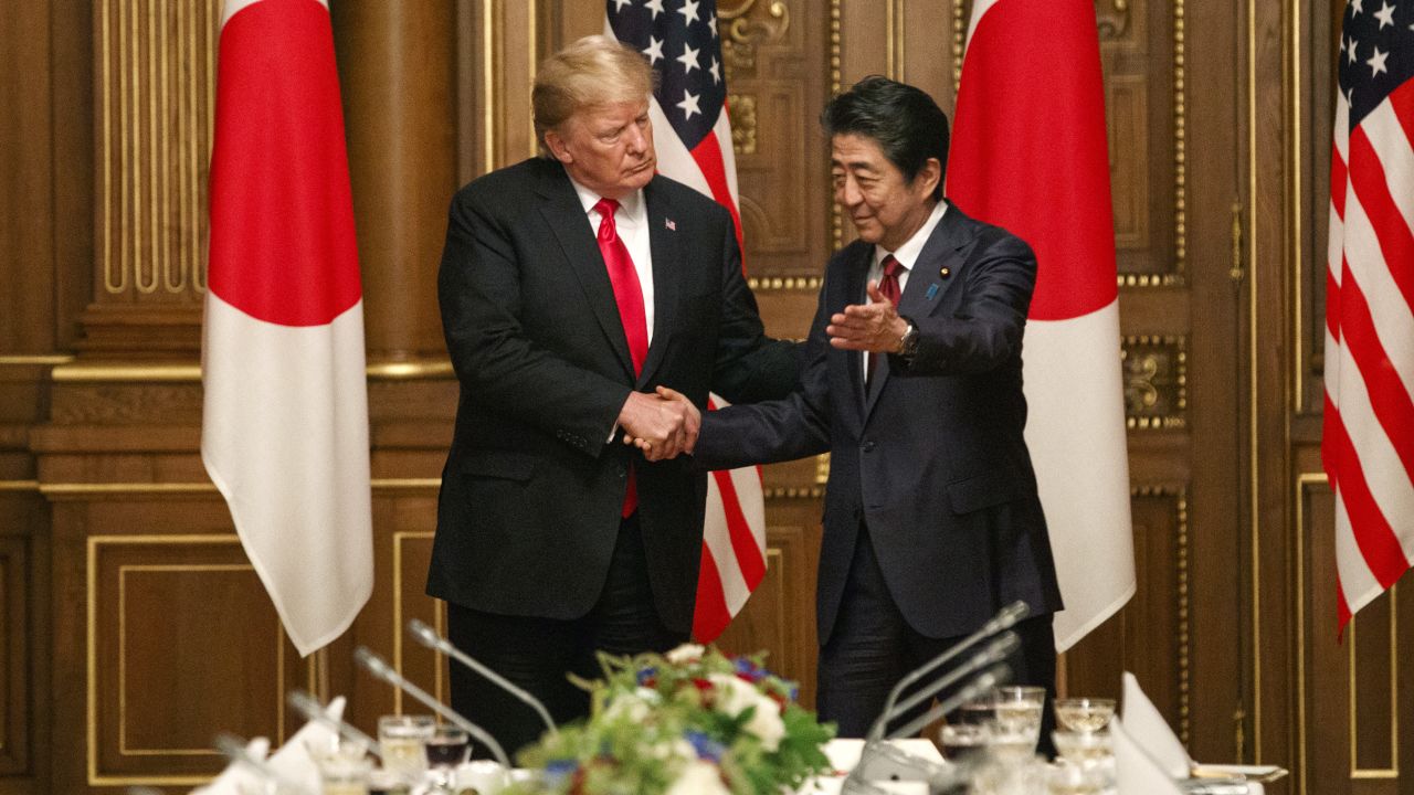 Donald Trump greets Shinzo Abe at Tokyo's Akasake Palace on Monday.