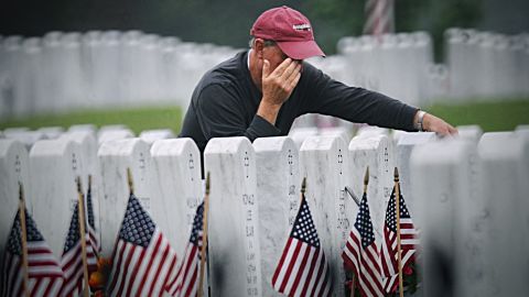 Dave Crafton pays his respects to his mother and father, who are both buried at the National Cemetery in Dayton, Ohio, on Monday, May 27. Crafton's father served in World War II.