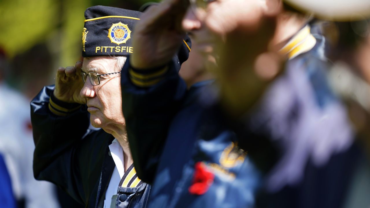 Vietnam veteran Joe Mack salutes during the National Anthem as a cemetery in Pittsfield, Massachusetts, commemorates Memorial Day.