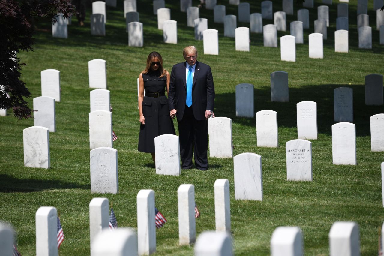 US President Donald Trump and his wife, Melania, visit Arlington National Cemetery on Thursday, May 23. They were visiting early because they would be in Japan on Memorial Day.