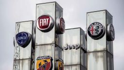 A picture taken on May 27, 2019 at a car dealer in Turin shows the logos of Lancia, Fiat, Abarth Jeep and Alfa Romeo auto makers, brands of Fiat Chrysler Automobiles (FCA) company. - French and Italian-US auto giants Renault and Fiat Chrysler are set to announce talks on an alliance, with a view to a potential merger, informed sources said on May 26, 2019. (Photo by MARCO BERTORELLO / AFP)        (Photo credit should read MARCO BERTORELLO/AFP/Getty Images)