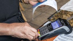 Miami Beach, Tropical Beach Cafe credit card scanner. (Photo by: Jeffrey Greenberg/UIG via Getty Images)