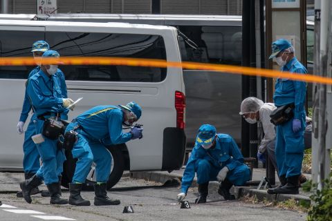 Police forensics officers work at the scene of a mass stabbing on May 28, in Kawasaki, Japan. At least 19  people, including children, were injured after a man attacked people with a knife near a park in the Noborito area of Kawasaki just outside Tokyo.