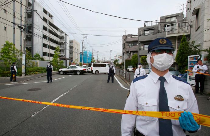 Police officers guard at the scene where a man wielding a knife attacked commuters in Kawasaki, near Tokyo on Tuesday, May 28.