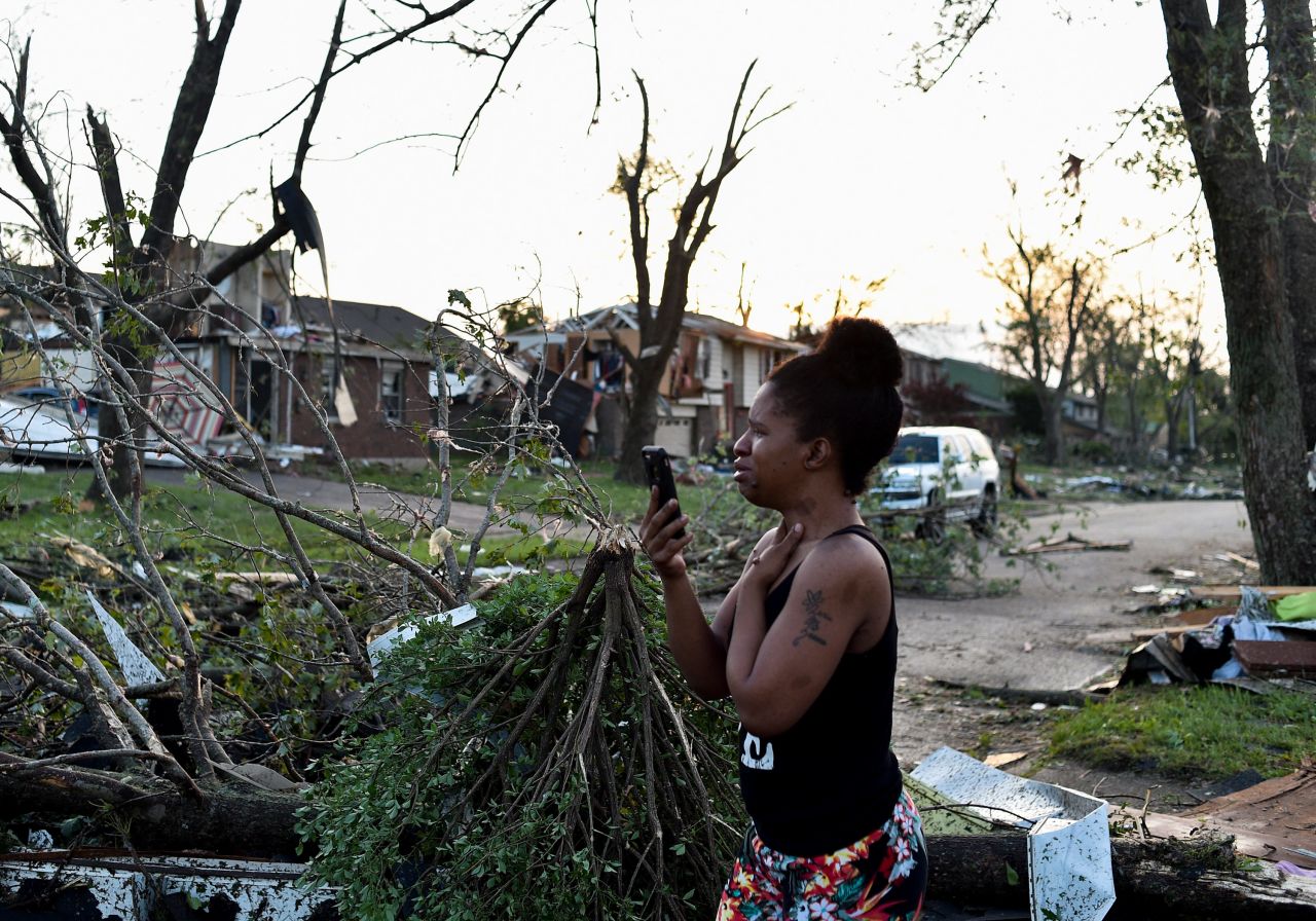 A Trotwood resident looks at damaged homes.