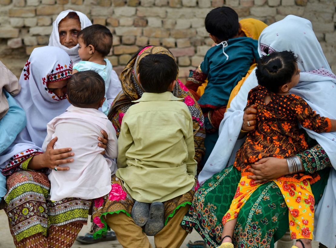 Pakistani women hold their HIV infected children as they gather at a house at Wasayo village in Rato Dero in the district of Larkana of the southern Sindh province on May 8, 2019. 