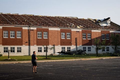 A man stands in the parking lot of Brookville High School.