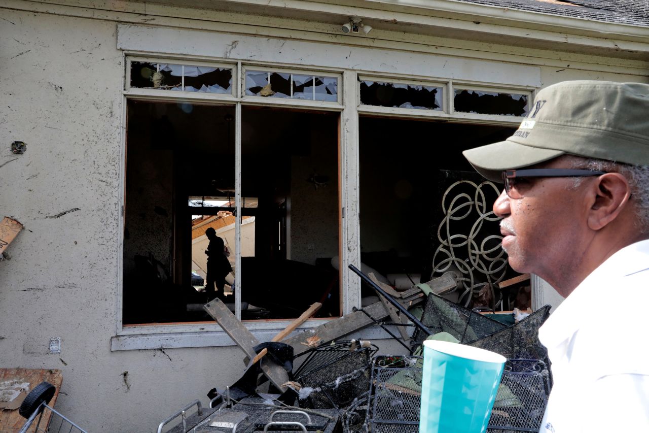 Daniel Williams walks through his damaged house in Clayton, Ohio.