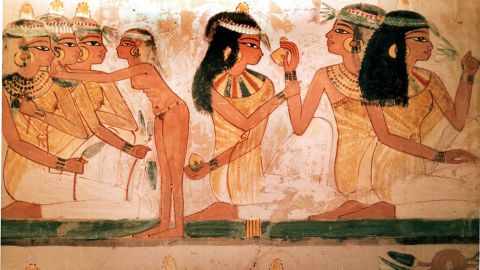A detail of a painting from the tomb of Nakht, found on the same bank of the Nile as this newer discovery, depicting three ladies at a feast. They wear perfumed cones in their hair and elaborate necklaces. 