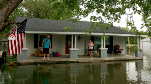 Nick Sweeney and his wife, Tara, watch the water level from their home in Portage Des Sioux, Missouri. 
