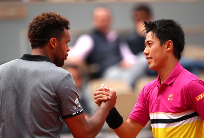 And in a battle of former grand slam finalists, Kei Nishikori (right) beat home hope Jo-Wilfried Tsonga in four sets. 