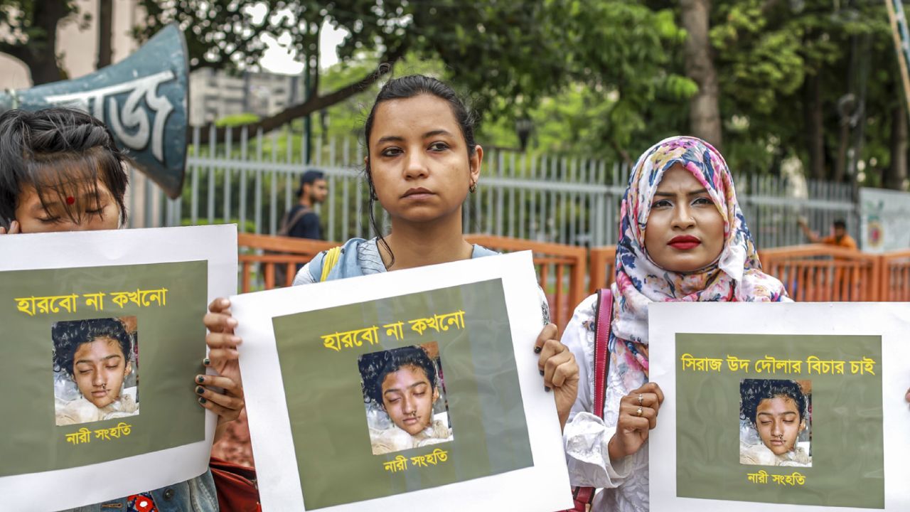 Bangladeshi women hold placards and photographs of schoolgirl Nusrat Jahan Rafi at a protest in Dhaka In this photo taken on April 12 following her murder. 