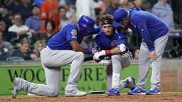 Chicago Cubs' Albert Almora Jr., center, takes a knee as Jason Heyward, left, and manager Joe Maddon, right, talk to him after hitting a foul ball into the stands during the fourth inning of a baseball game against the Houston Astros Wednesday, May 29, 2019, in Houston. (AP Photo/David J. Phillip)