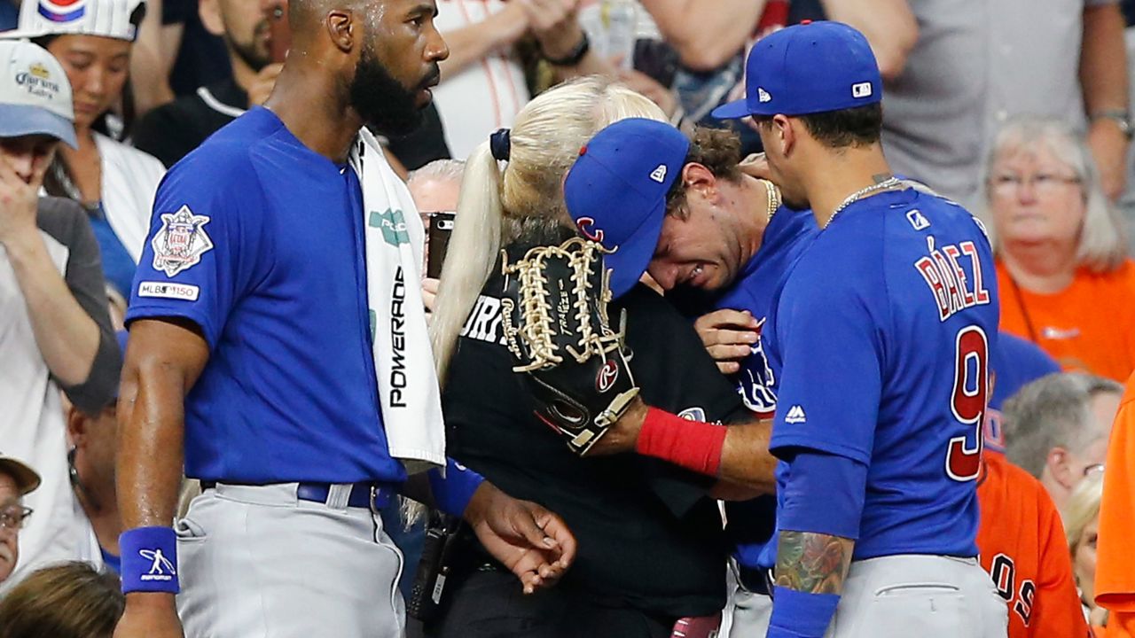 Albert Almora Jr. of the Chicago Cubs, center, is comforted after a young fan was hit by a foul ball.