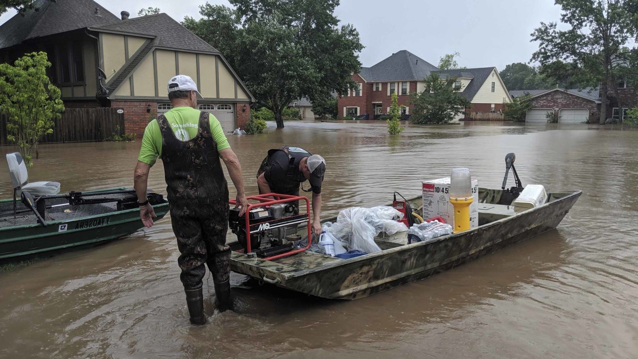 Brad Hindley and his son, Bart, pull a boat Wednesday to Brad's home in Fort Smith, Arkansas.