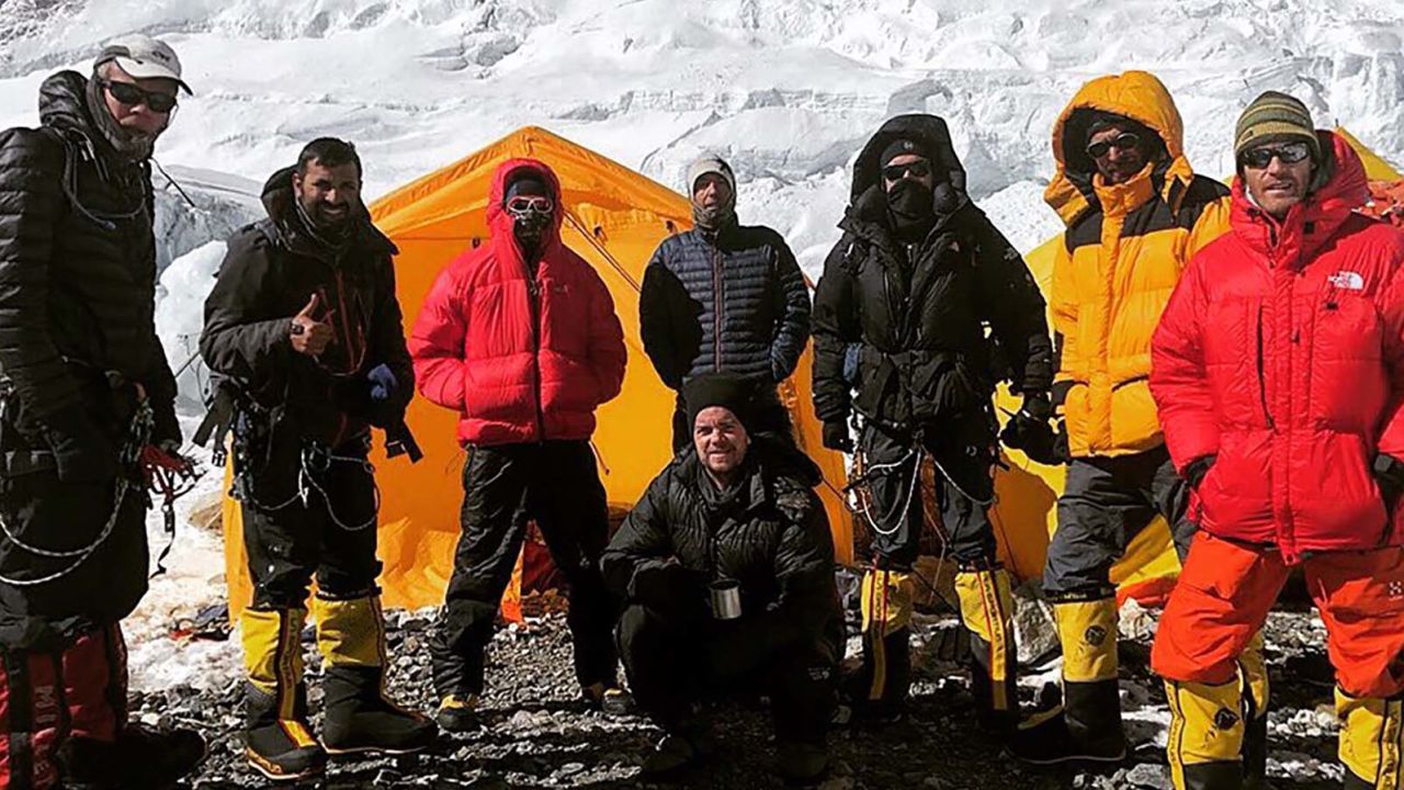 Robin is pictured third from right, in black, among a group of other climbers.