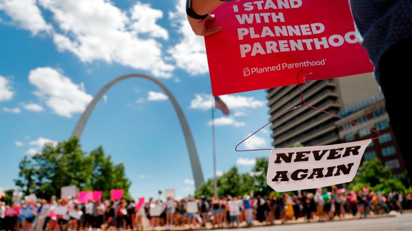 Abortion-rights supporters stand on both sides of a street near the Gateway Arch as they take part in a protest in favor of reproductive rights Thursday, May 30, 2019, in St. Louis. A St. Louis judge heard an hour of arguments Thursday on Planned Parenthood's request for a temporary restraining order that would prohibit the state from allowing the license for Missouri's only abortion clinic to lapse at midnight Friday. (AP Photo/Jeff Roberson)