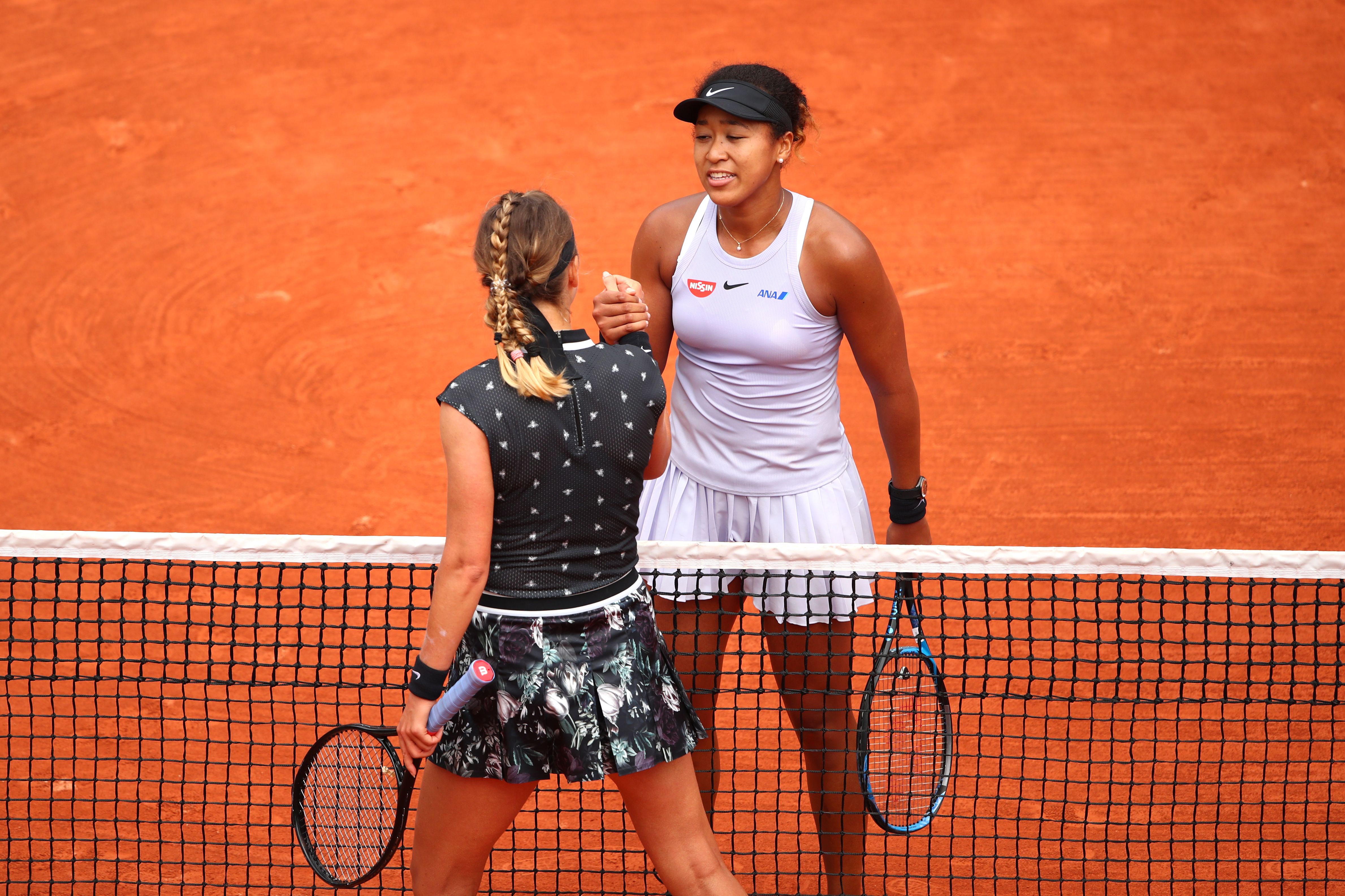 Naomi Osaka versus Victoria Azarenka promised to be the blockbuster second-round match at the French Open. It was just that, with Osaka (wearing cap) prevailing.
