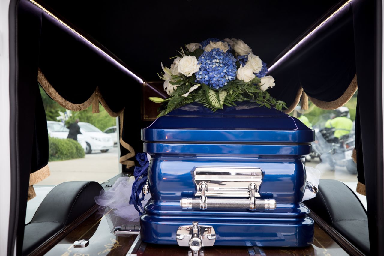 Blue and white were the colors of the funeral. Houston's mother said they were her favorite colors, but someone else said her favorite color was pink. Guests wore blue and white, and Booker's blue casket matched her bejeweled dress.