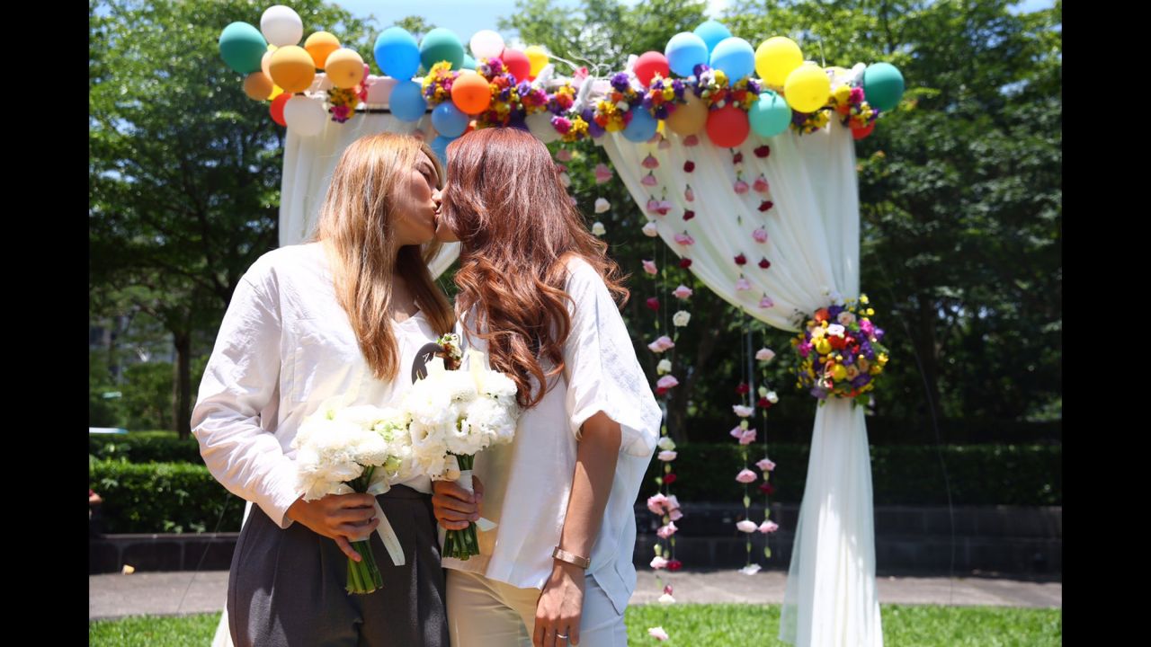 Kristin Huang, left, and Amber Wang kiss during their wedding in Taipei, Taiwan, on Friday, May 24. They were making history as one of <a href="https://www.cnn.com/2019/05/24/asia/gallery/taiwan-same-sex-marriages/index.html" target="_blank">the first same-sex couples to marry in Asia.</a>