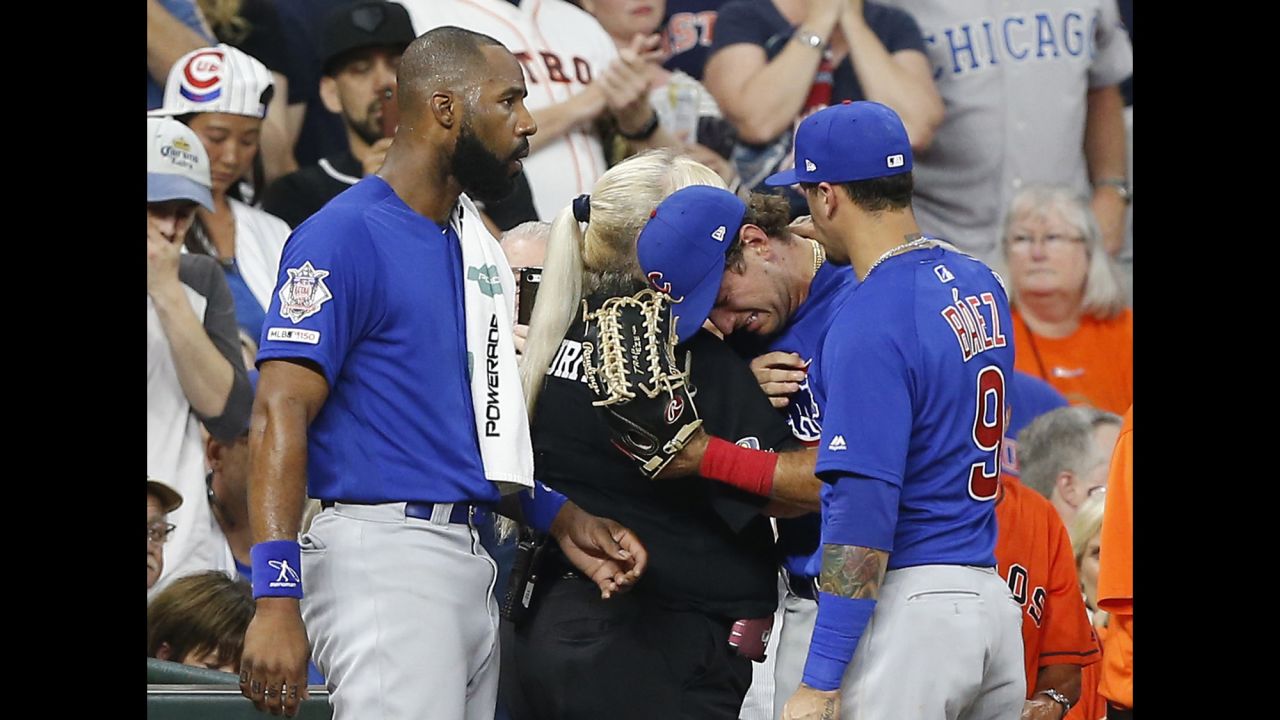 Chicago Cubs outfielder Albert Almora Jr. is comforted by a security guard after checking in on the status of a young girl <a href="https://www.cnn.com/2019/05/30/us/houston-foul-ball-hurts-child-trnd/index.html" target="_blank">who was struck by a foul ball he hit</a> in Houston on Wednesday, May 29. Almora was distraught by the incident, throwing his hands behind his head immediately after seeing the impact. The girl was taken to a hospital, but her condition was not immediately available.