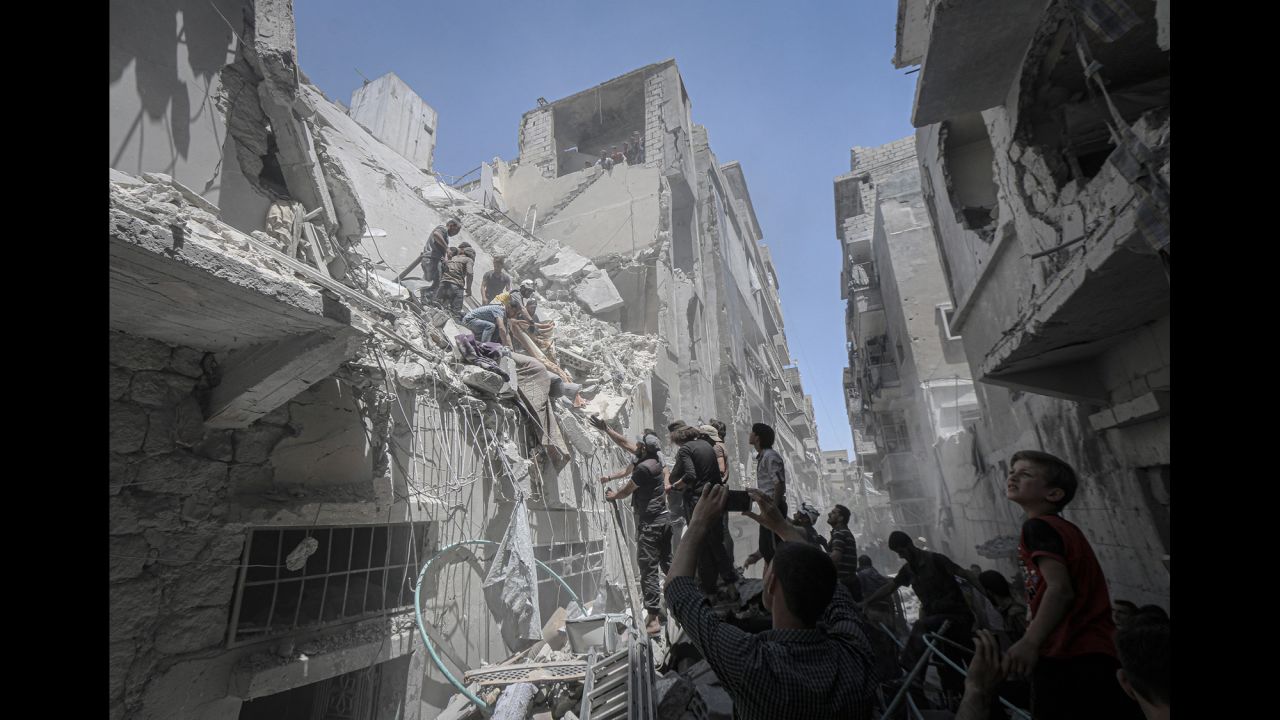 Rescuers work at the scene of an airstrike in Idlib, Syria, on Monday, May 27. The fighting in Syria's last rebel-held province <a href="https://www.cnn.com/2019/05/29/middleeast/idlib-bombing-slider-intl/index.html" target="_blank">has left a trail of damage visible from space.</a>