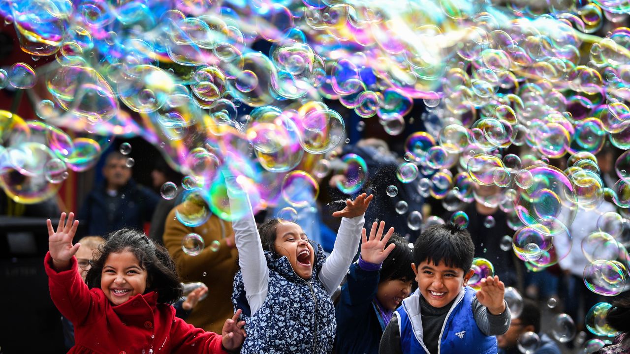 Children play in bubbles during a street performance in Edinburgh, Scotland, on Monday, May 27.