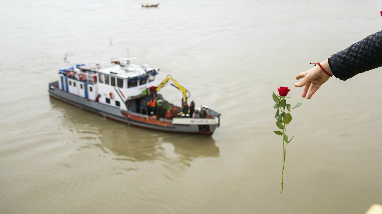 A woman in Budapest, Hungary, throws a flower from the Margaret Bridge during a search operation on the Danube river on Thursday, May 30. A <a href="https://www.cnn.com/2019/05/29/europe/hungary-sightseeing-boat-sinks-on-danube-river/index.html" target="_blank">riverboat collision</a> killed at least seven people and left 21 missing.<br />